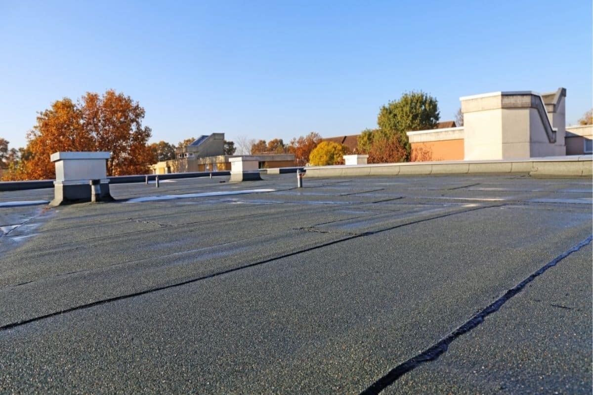 Ponding Water On Flat Roofs: Causes & Fixes