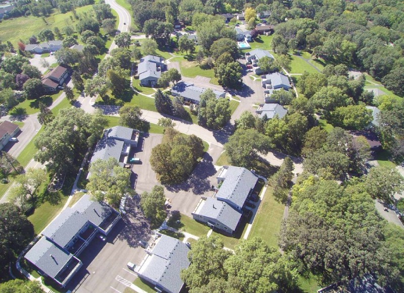 Aerial view of a townhome community with newly installed gray shingle roofs