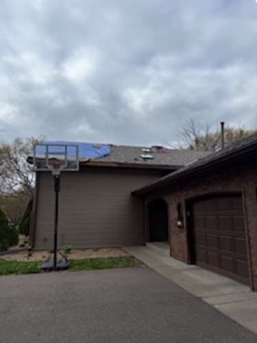 Tarped section of a Blaine home's roof after emergency tree-damage response