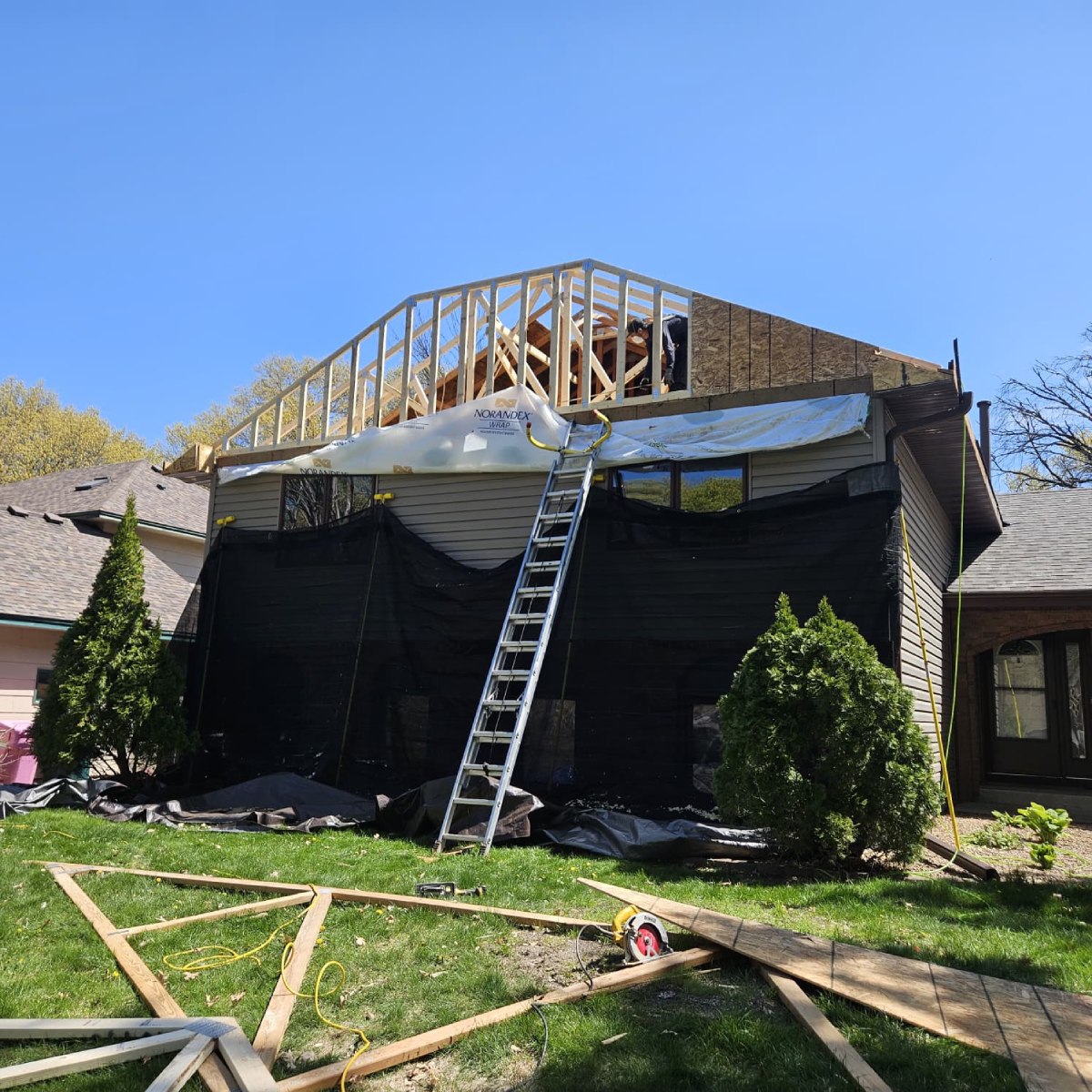Blaine home with emergency tarp covering roof and wall damage from a fallen tree