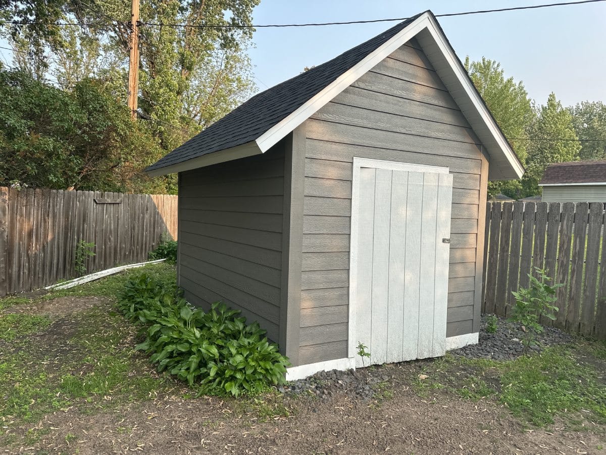 Gray shed with white door